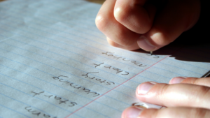 A child writing spelling words