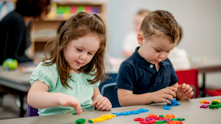 Two children playing with letters