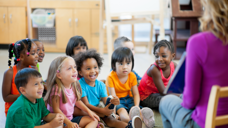 Young children looking at an adult