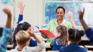 Women smiling at a group of students