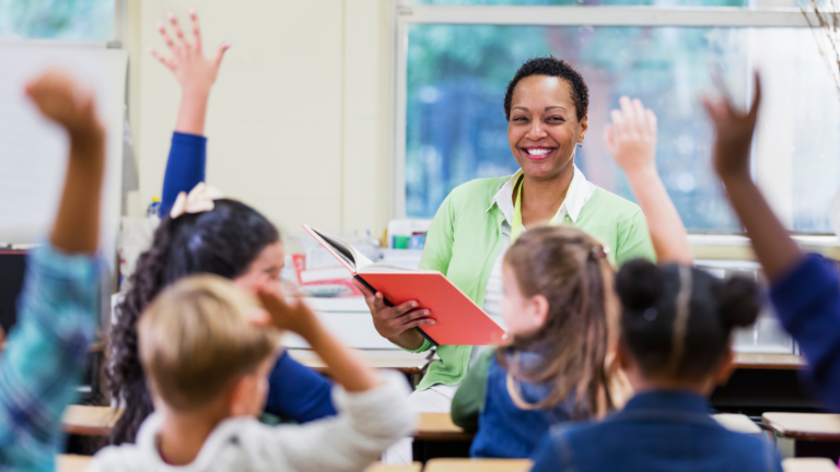 Women smiling at a group of students